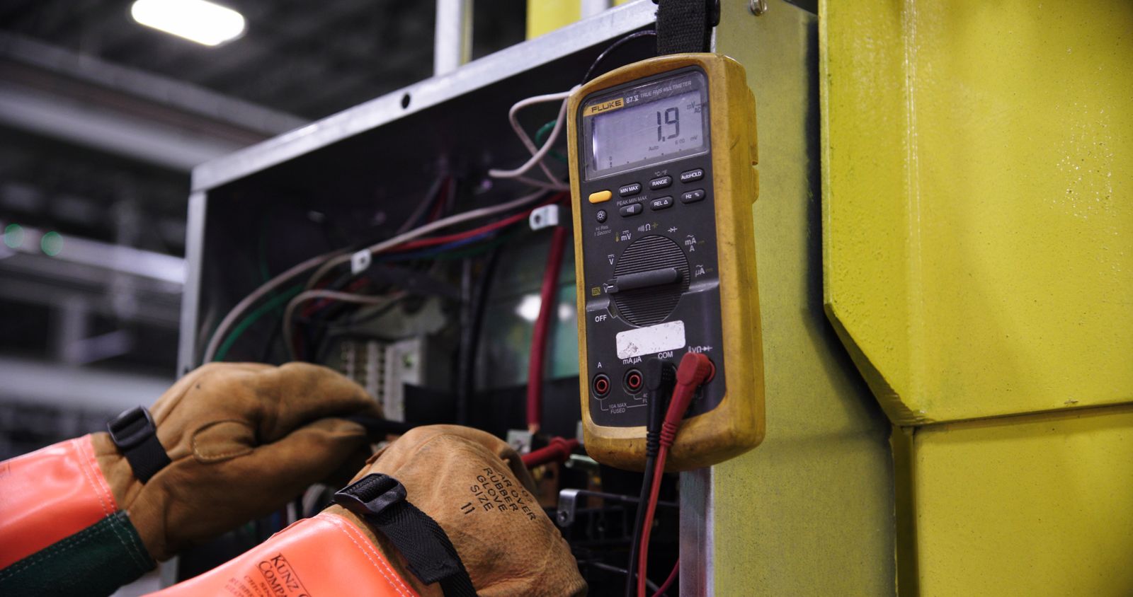 Technician performing electrical maintenance